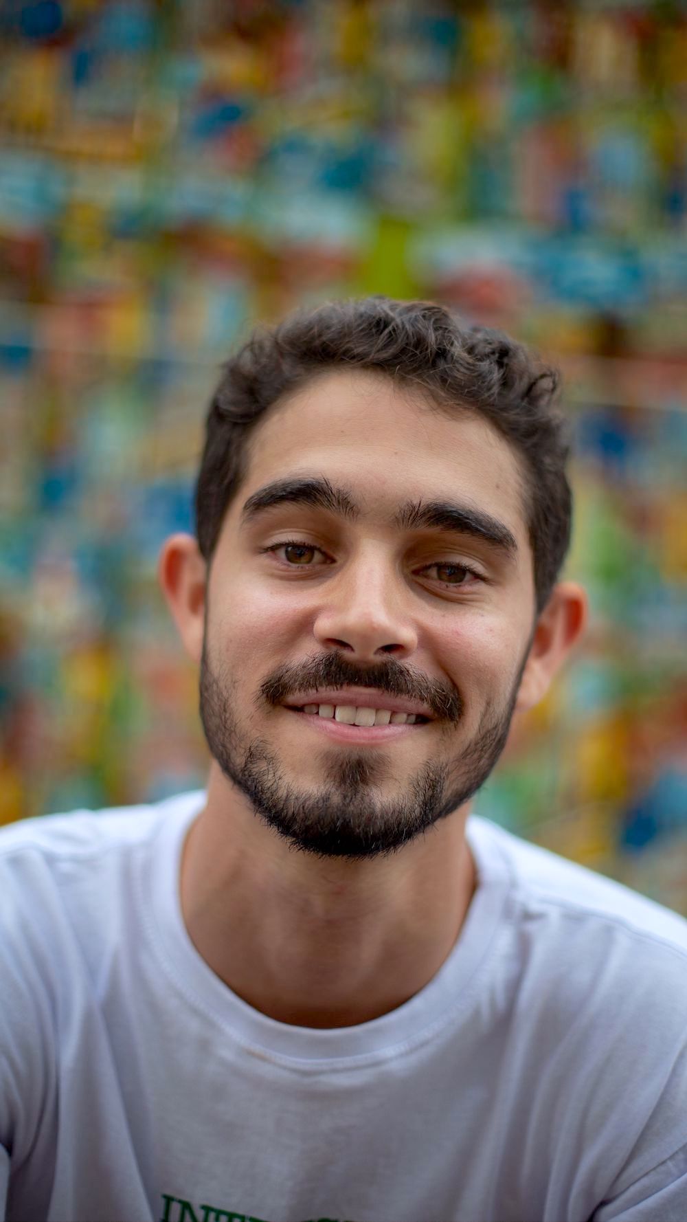 Hispanic man in his 30s looking at camera and smiling