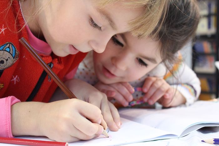 Closeup of happy children writing together