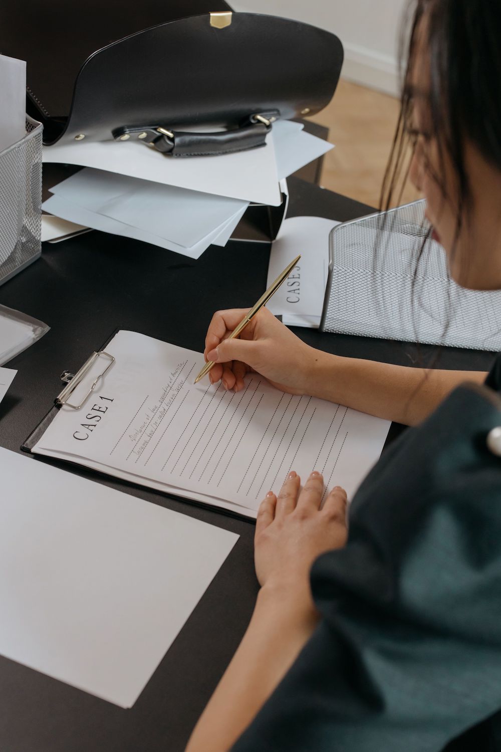 Professional woman reviewing case notes. Focus on the notes.